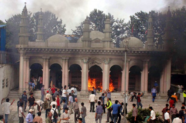 Protesters attack a burning mosque in Katmandu, Nepal in 2004, to protest the killing of 12 Nepalese hostages by Iraqi militants. 