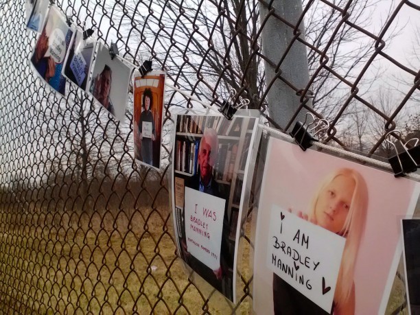 Bradley Manning supporters decorated a security fence with photos during a rally outside Fort Meade on Tuesday.