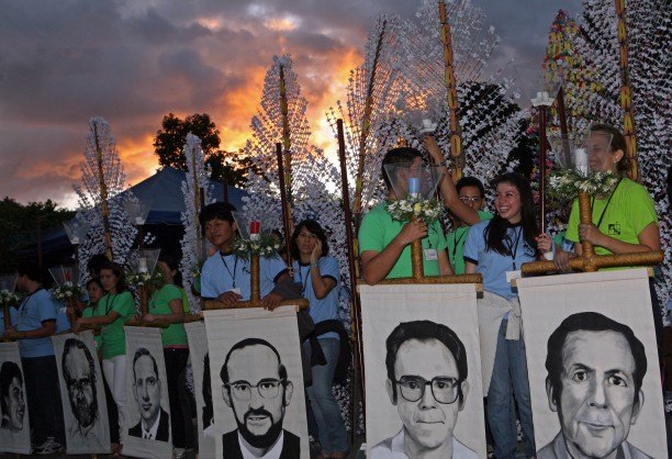 Students of the Central American University Jose Simeon Canas hold portraits of the six Jesuit priests from Spain, that were killed by the Salvadoran Army during the civil war in 1989, as they participate in a tribute ceremony in the 21st anniversary of their execution in San Salvador, El Salvador, Saturday Nov. 13, 2010.