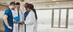 diverse-medical-team-consulting-on-a-patient-T3B9PKW.jpg