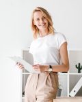 smiling-businesswoman-holding-folder-8PBUAH4.jpg