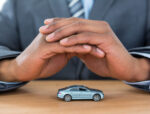 businessman-protecting-toy-car-with-hands-MF2VUC5-1.jpg
